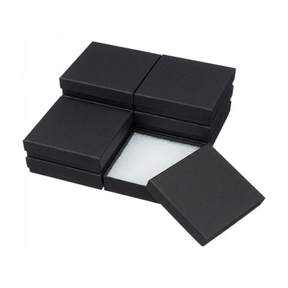 Black jewelry box with a white cotton fill interior on a white background